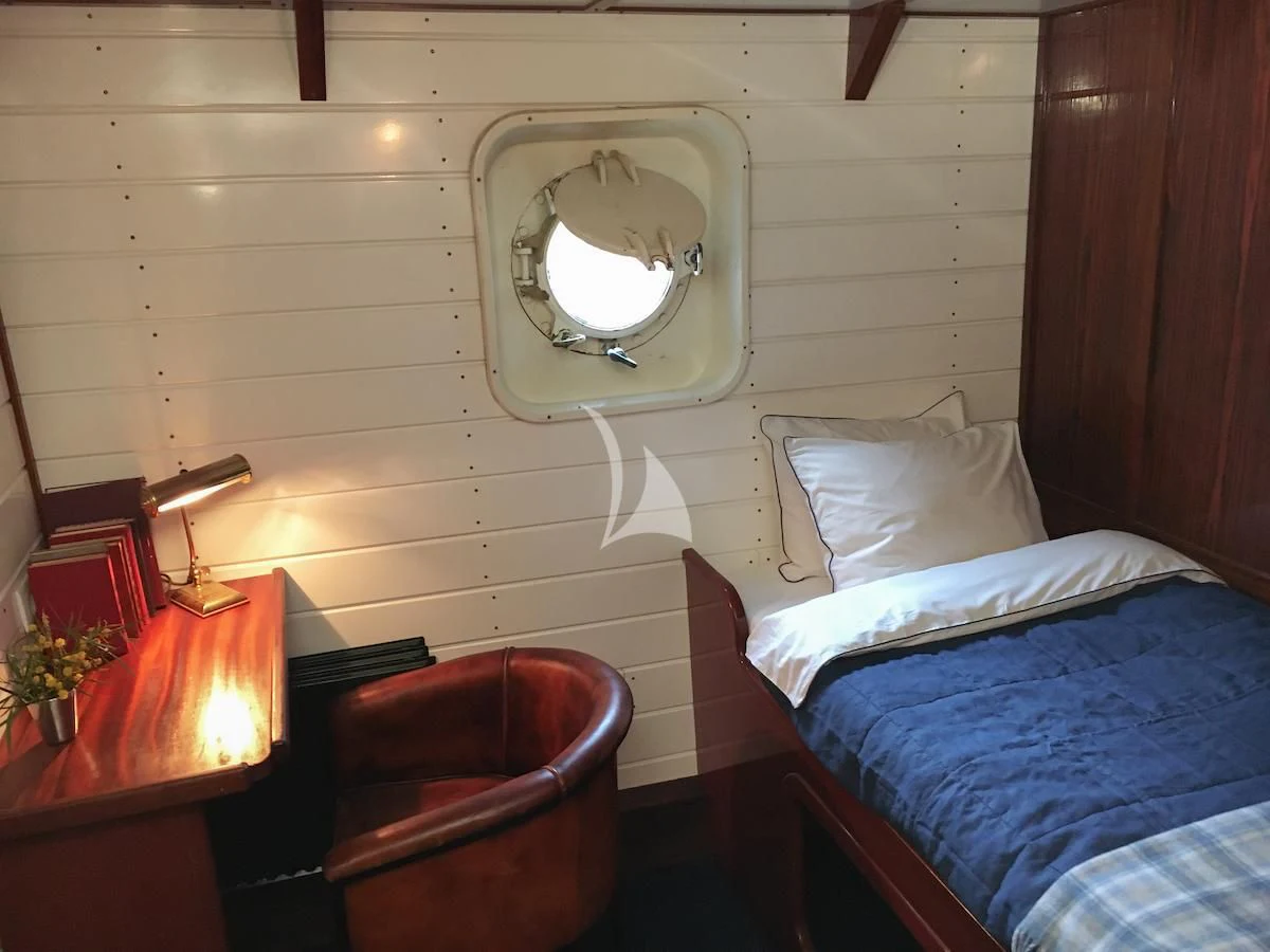 a bed with a mirror above it aboard BALTO Yacht for Sale