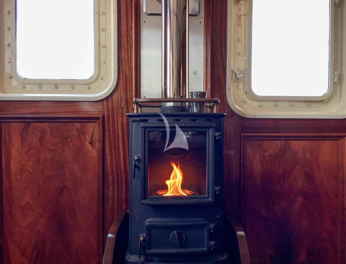 a black object with a flame on it by a window aboard BALTO Yacht for Sale