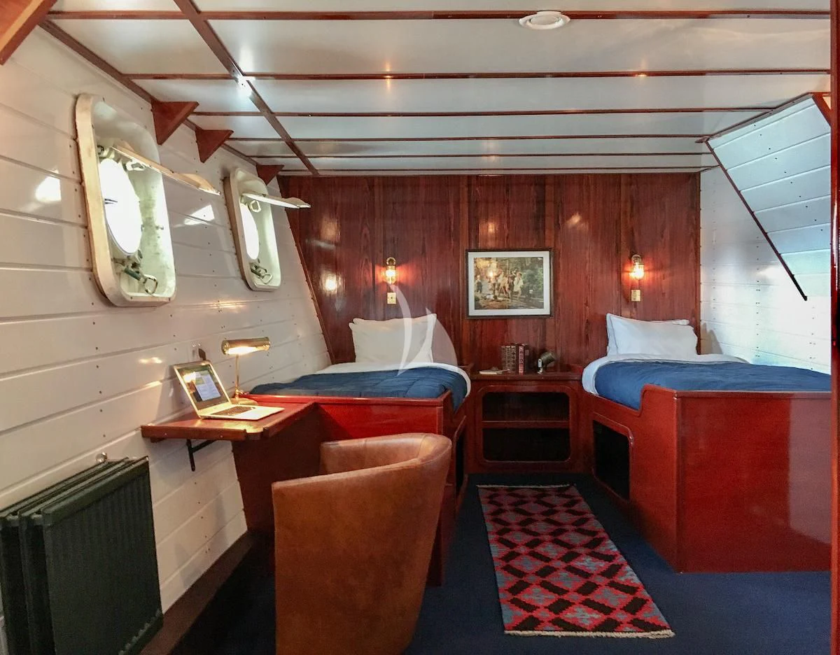 a room with a bed and a desk aboard BALTO Yacht for Sale