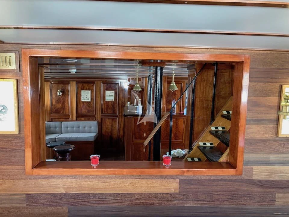 a room with a wood floor and a staircase aboard BALTO Yacht for Sale