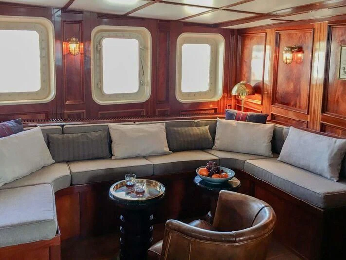 a living room with a couch and a coffee table aboard BALTO Yacht for Sale