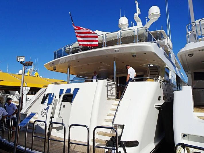 a boat with a flag on the deck aboard LADY JJ Yacht for Charter