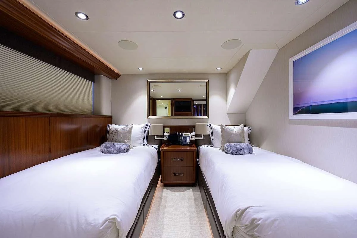 a room with a bed and a television aboard LADY JJ Yacht for Charter