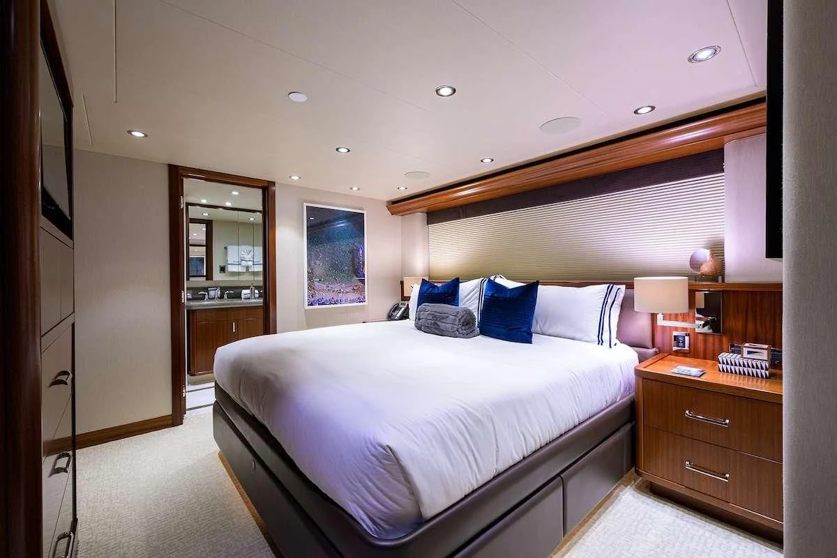 a bedroom with a bed and a dresser aboard LADY JJ Yacht for Charter