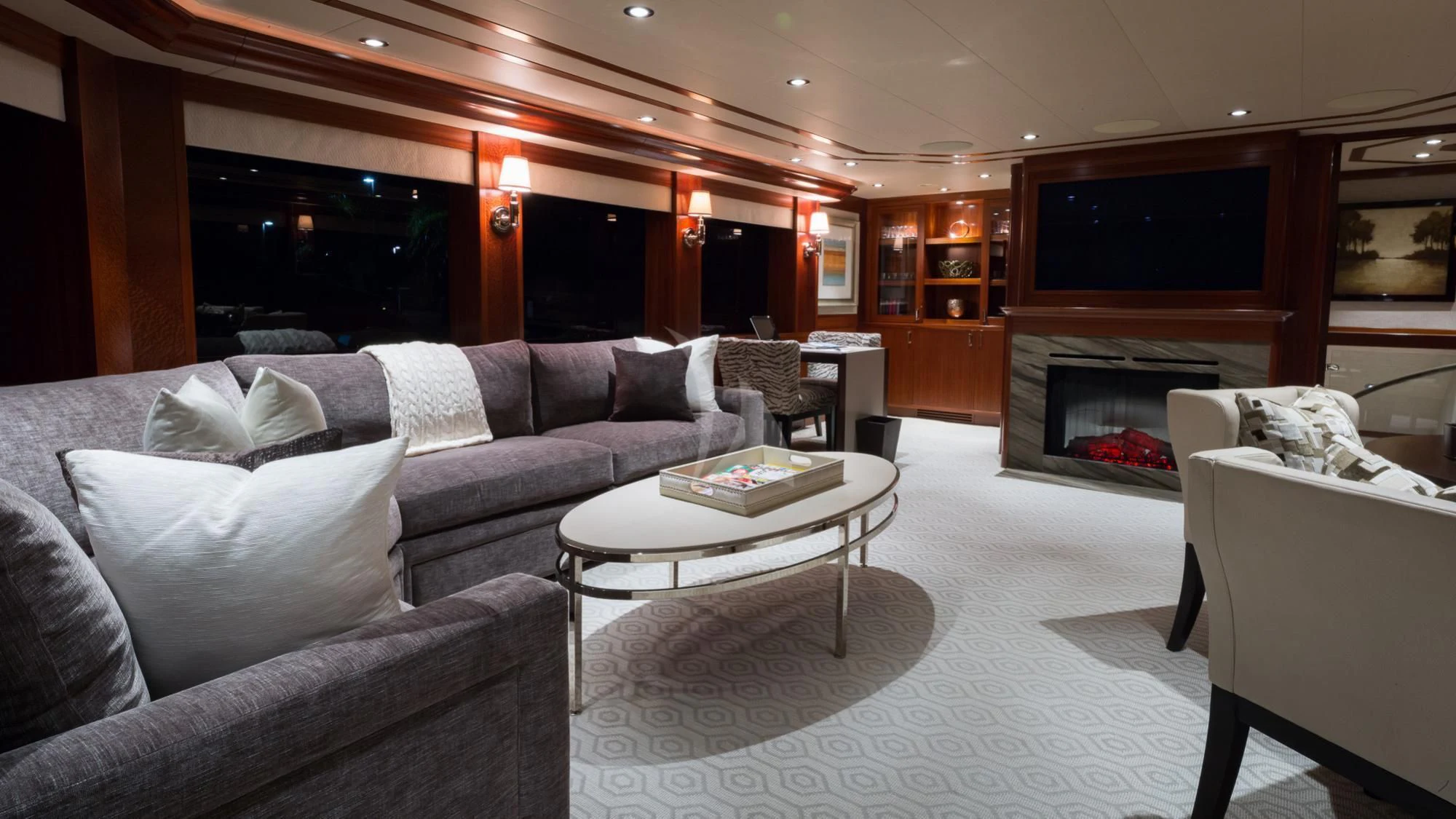 a living room with a fireplace aboard LADY JJ Yacht for Charter