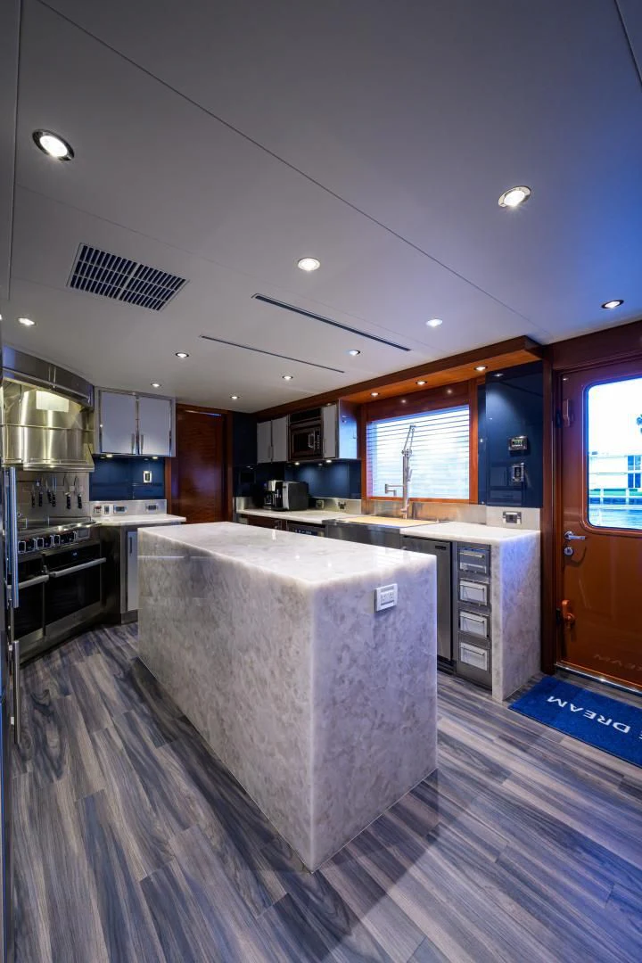 a large kitchen with a large island aboard LADY JJ Yacht for Charter