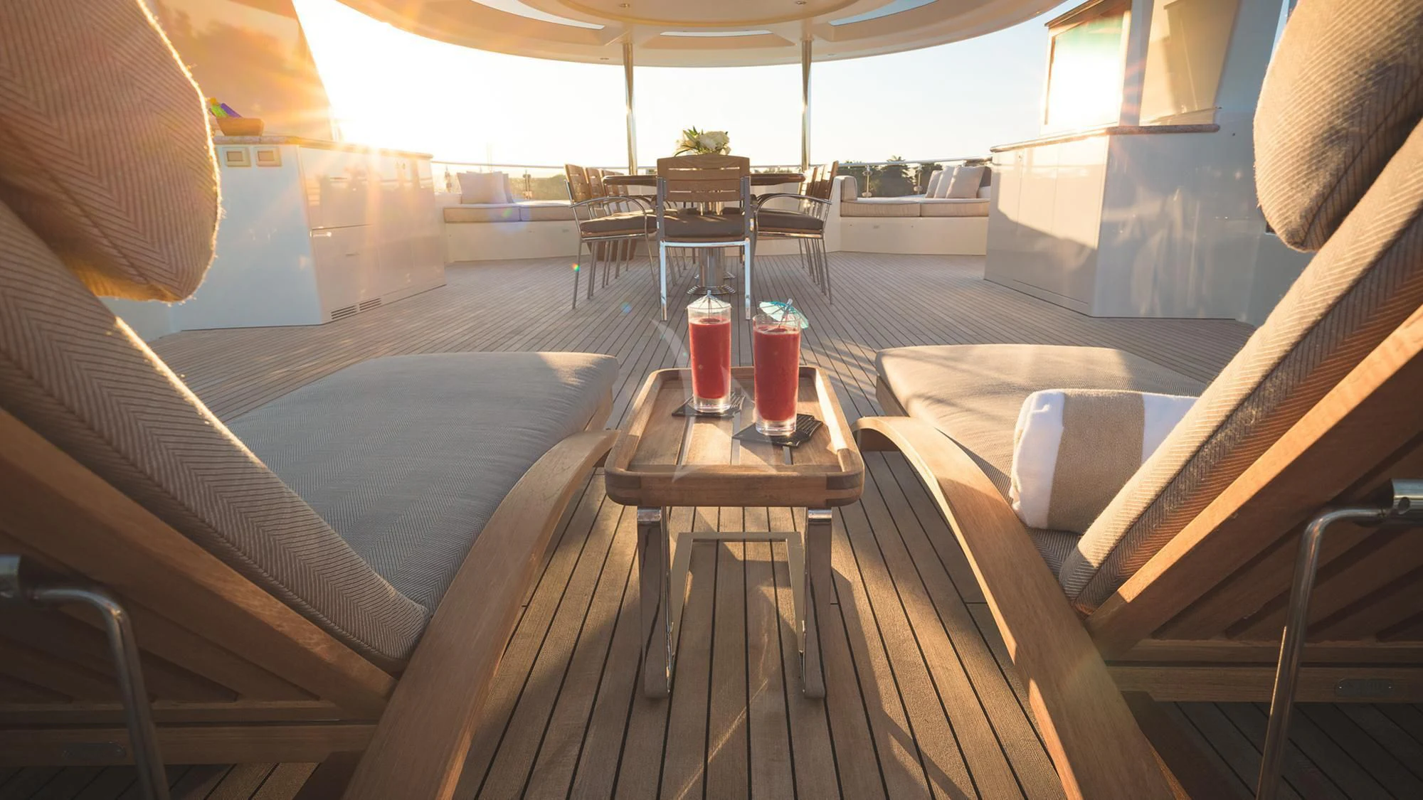 a wooden deck with a table and chairs aboard LADY JJ Yacht for Charter