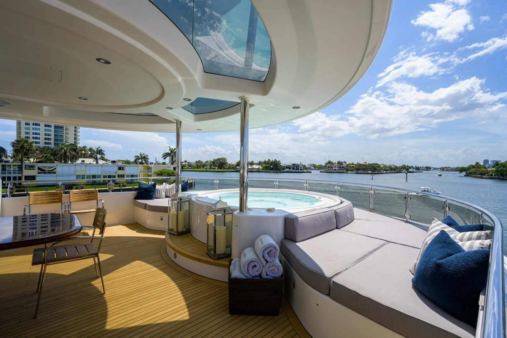 a room with a large balcony overlooking a body of water aboard LADY JJ Yacht for Charter