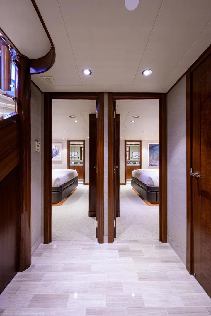 a hallway with a bed and a mirror aboard LADY JJ Yacht for Charter