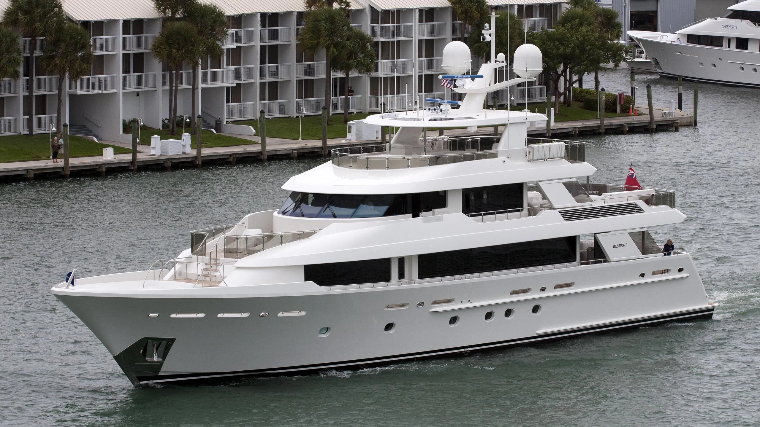 a white yacht docked at a pier aboard LADY JJ Yacht for Charter
