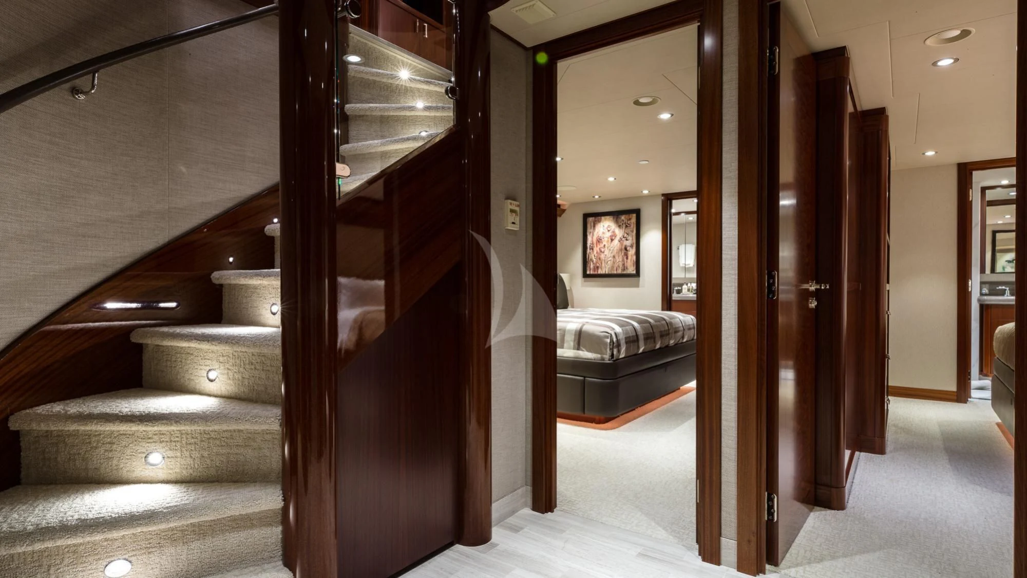 a room with a bed and a wood staircase aboard LADY JJ Yacht for Charter