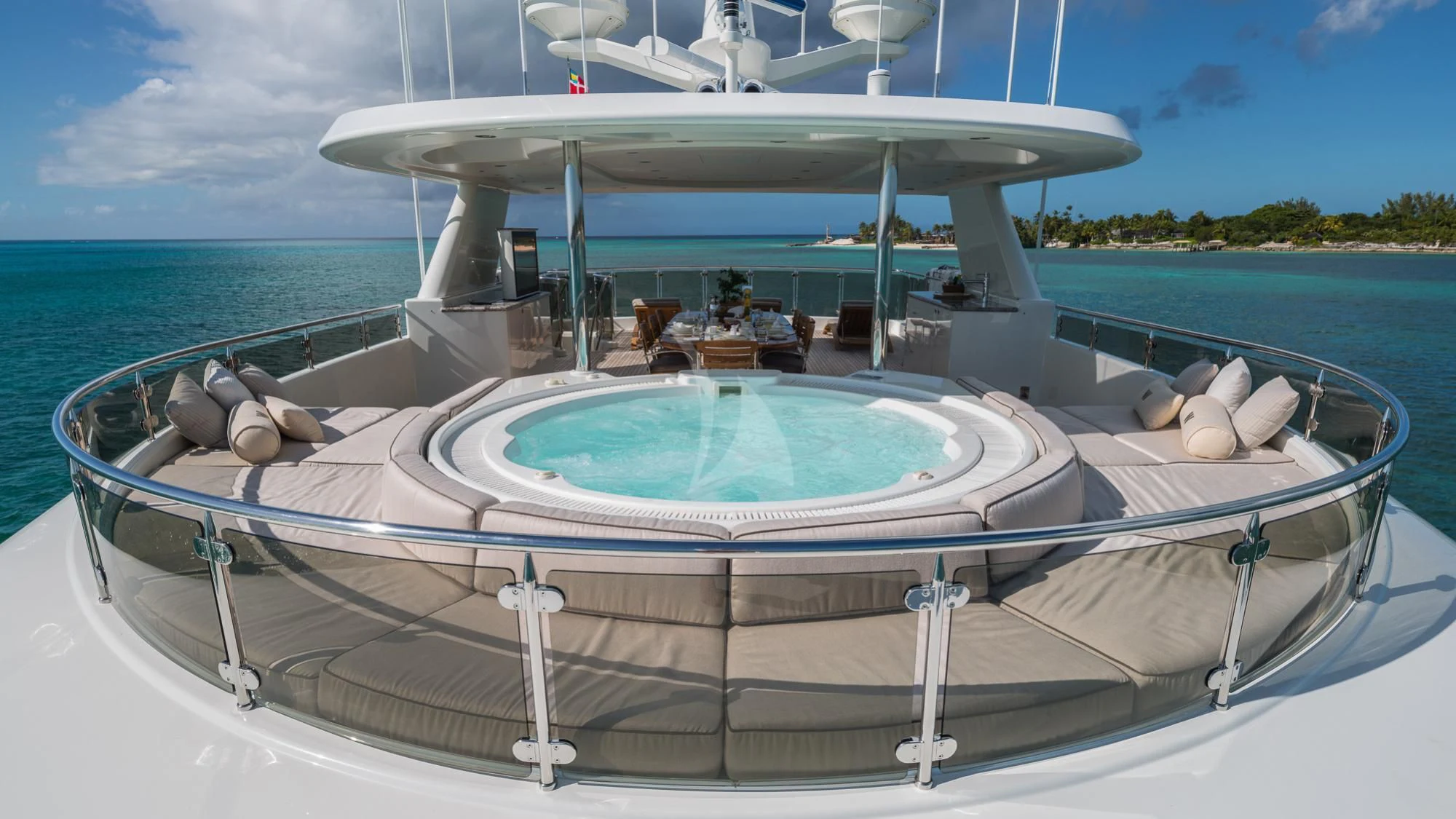 a large pool with a large round table and chairs on a boat aboard LADY JJ Yacht for Charter