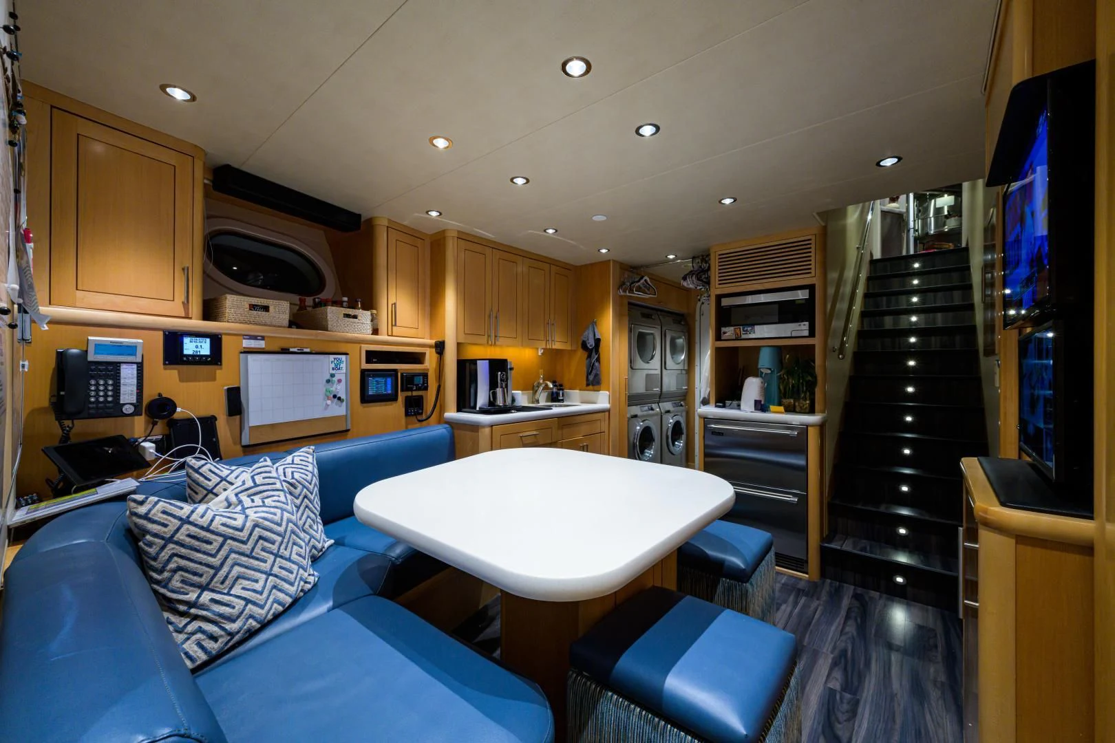 a room with a table and a tv aboard LADY JJ Yacht for Charter
