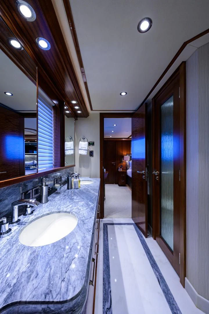 a bathroom with a countertop sink and a mirror aboard LADY JJ Yacht for Charter