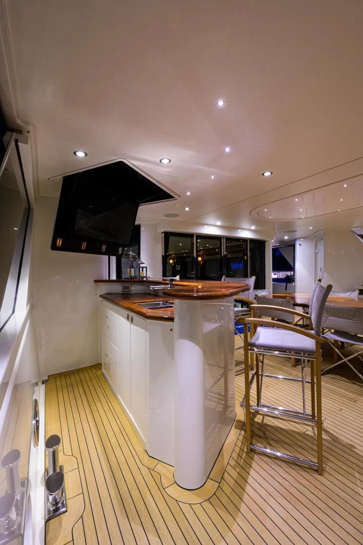 a kitchen with a bar and a table aboard LADY JJ Yacht for Charter