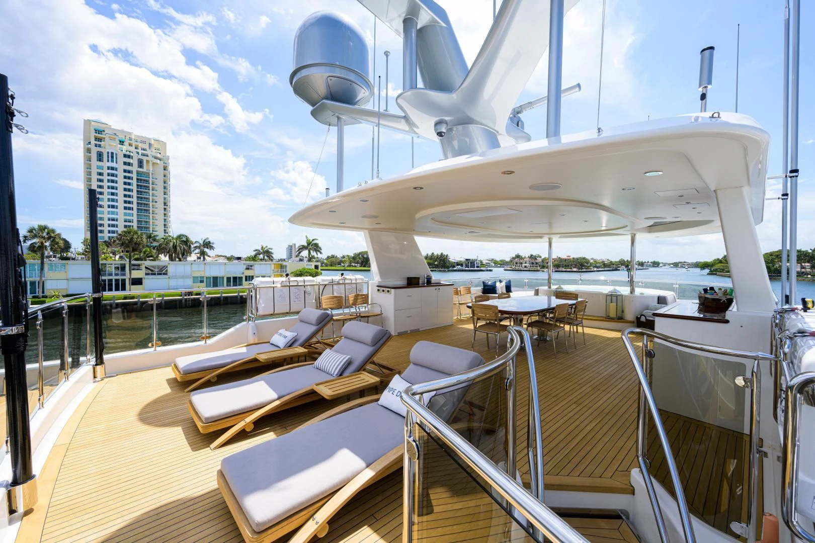 a deck with a boat and a deck with a building and trees aboard LADY JJ Yacht for Charter
