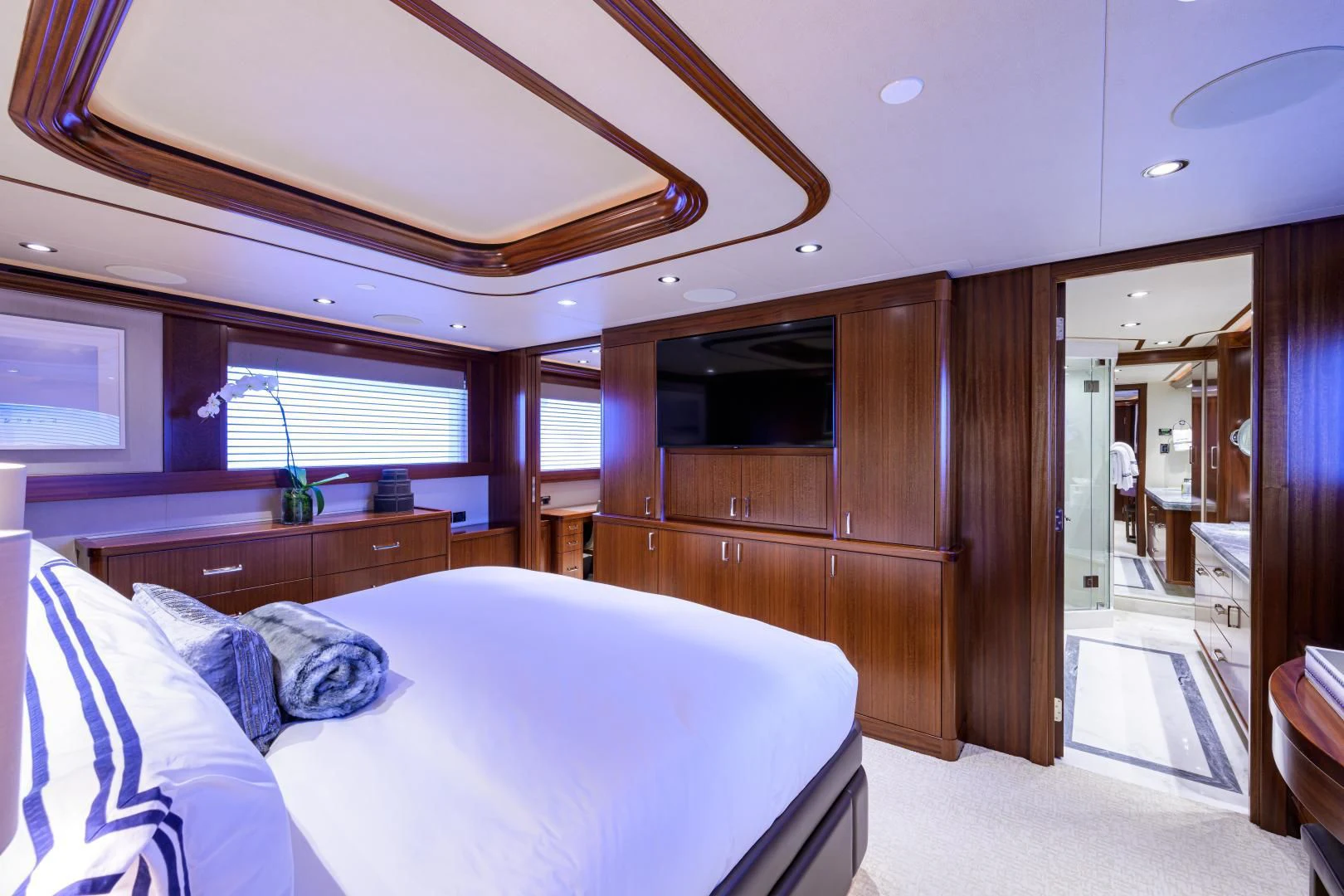 a bedroom with a bed and a wood closet aboard LADY JJ Yacht for Charter