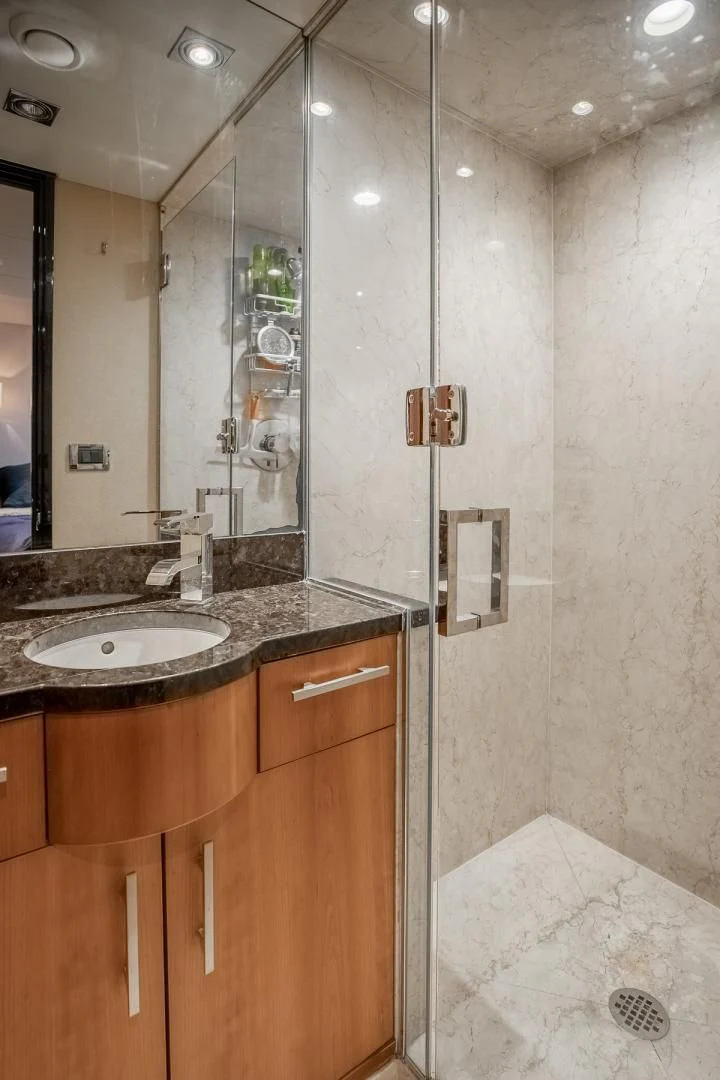 a bathroom with a glass shower aboard FUGITIVE *NAME RESERVED* Yacht for Sale