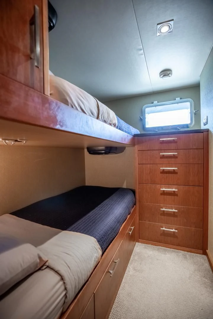 a bed with a tv on top of it aboard FUGITIVE *NAME RESERVED* Yacht for Sale