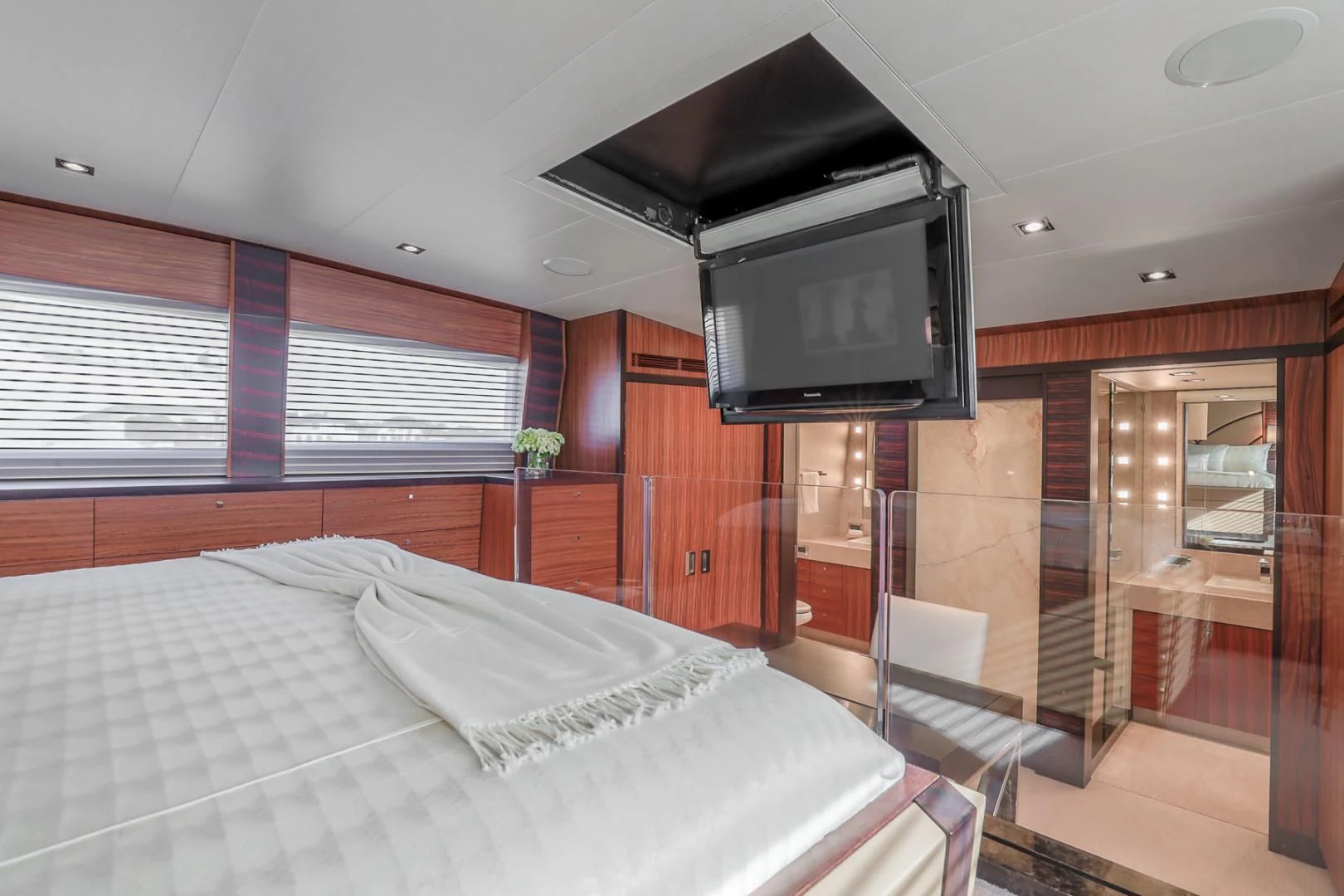 a bedroom with a bed and a tv aboard FUGITIVE *NAME RESERVED* Yacht for Sale