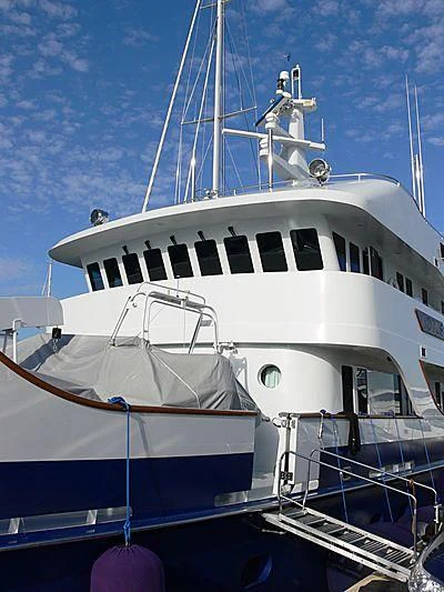 a white boat with a white stripe aboard LOTUS Yacht for Sale