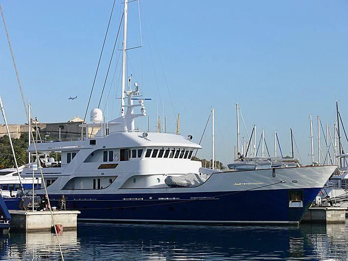 a large white boat in a harbor aboard LOTUS Yacht for Sale