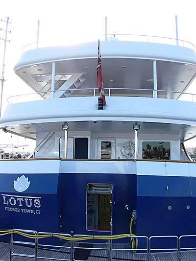 a boat with a flag on the deck aboard LOTUS Yacht for Sale