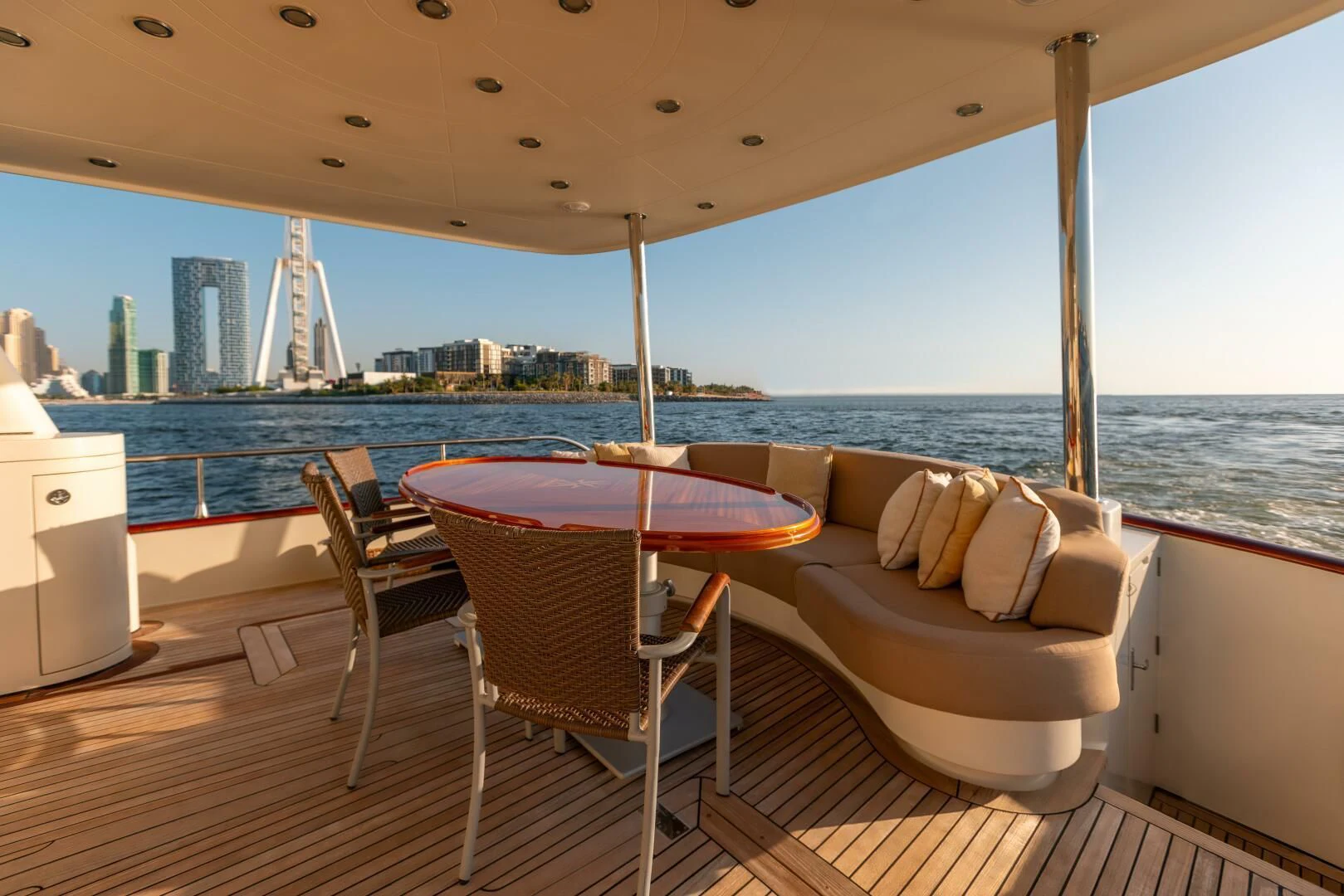 a table and chairs on a deck overlooking a city aboard ANTALYA Yacht for Sale