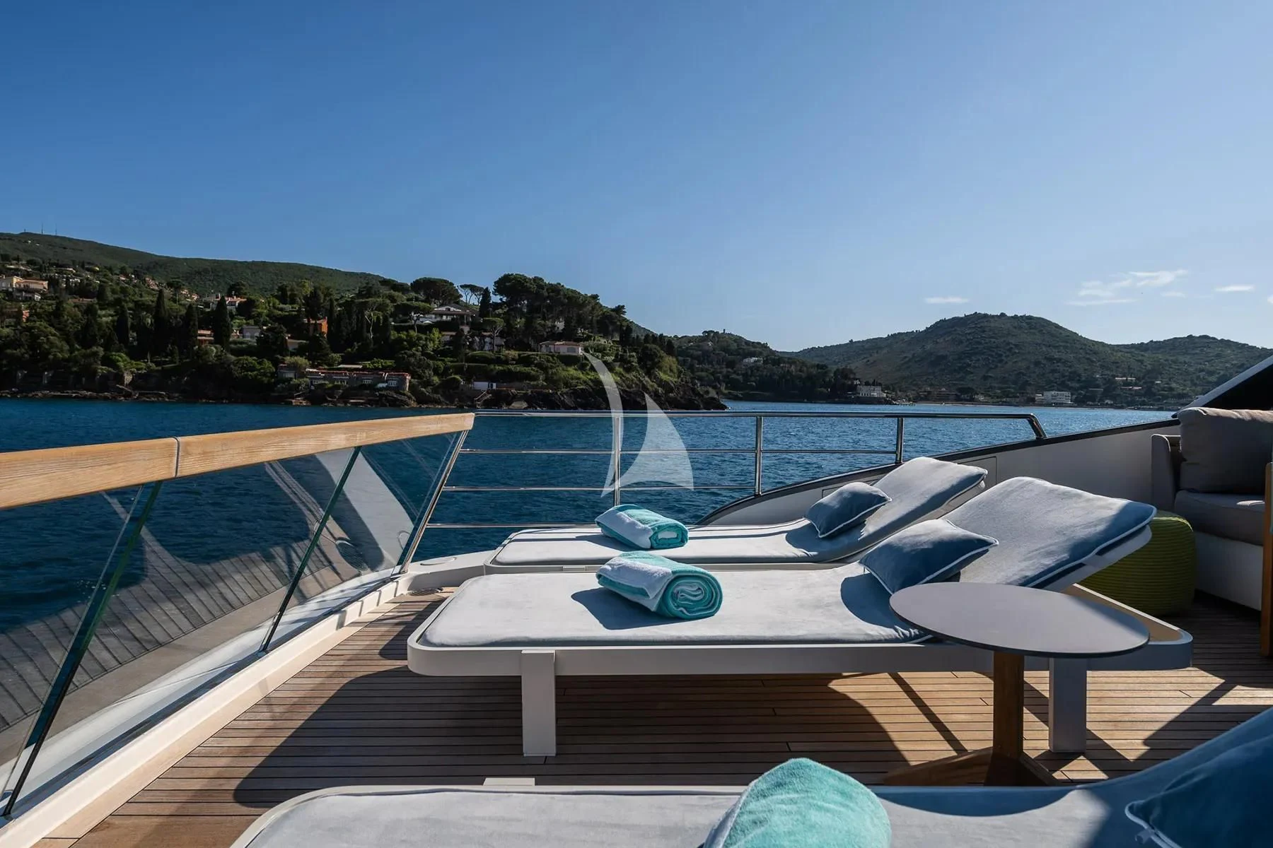 a pool on a deck overlooking a beach aboard PEMBE Yacht for Charter