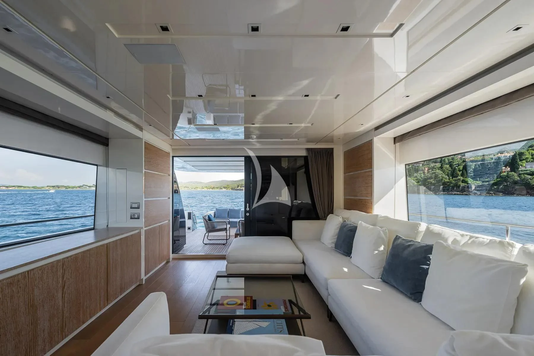 a living room with a large window aboard PEMBE Yacht for Charter