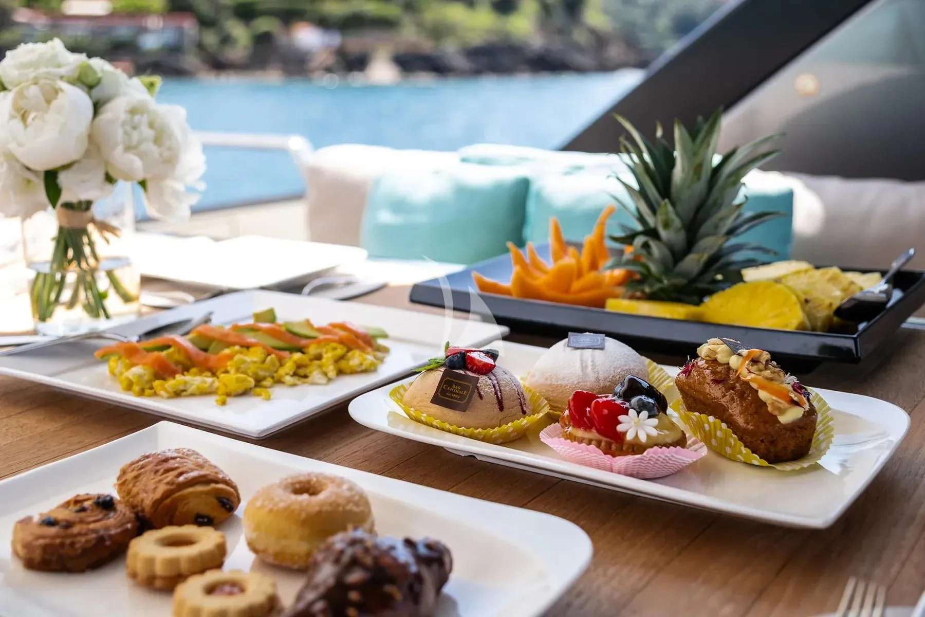 a table with plates of food aboard PEMBE Yacht for Charter