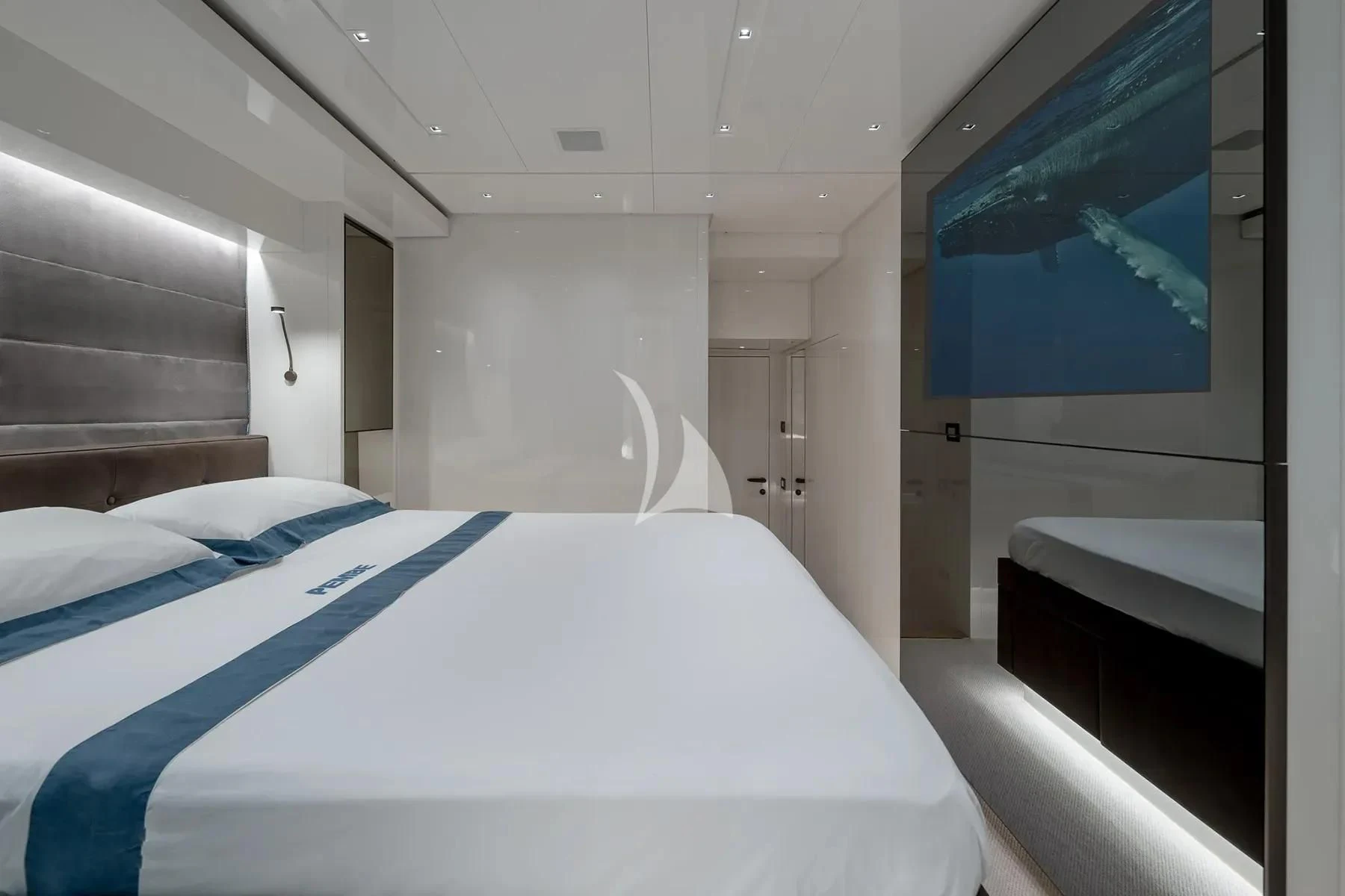 a room with a bed and a painting on the wall aboard PEMBE Yacht for Charter