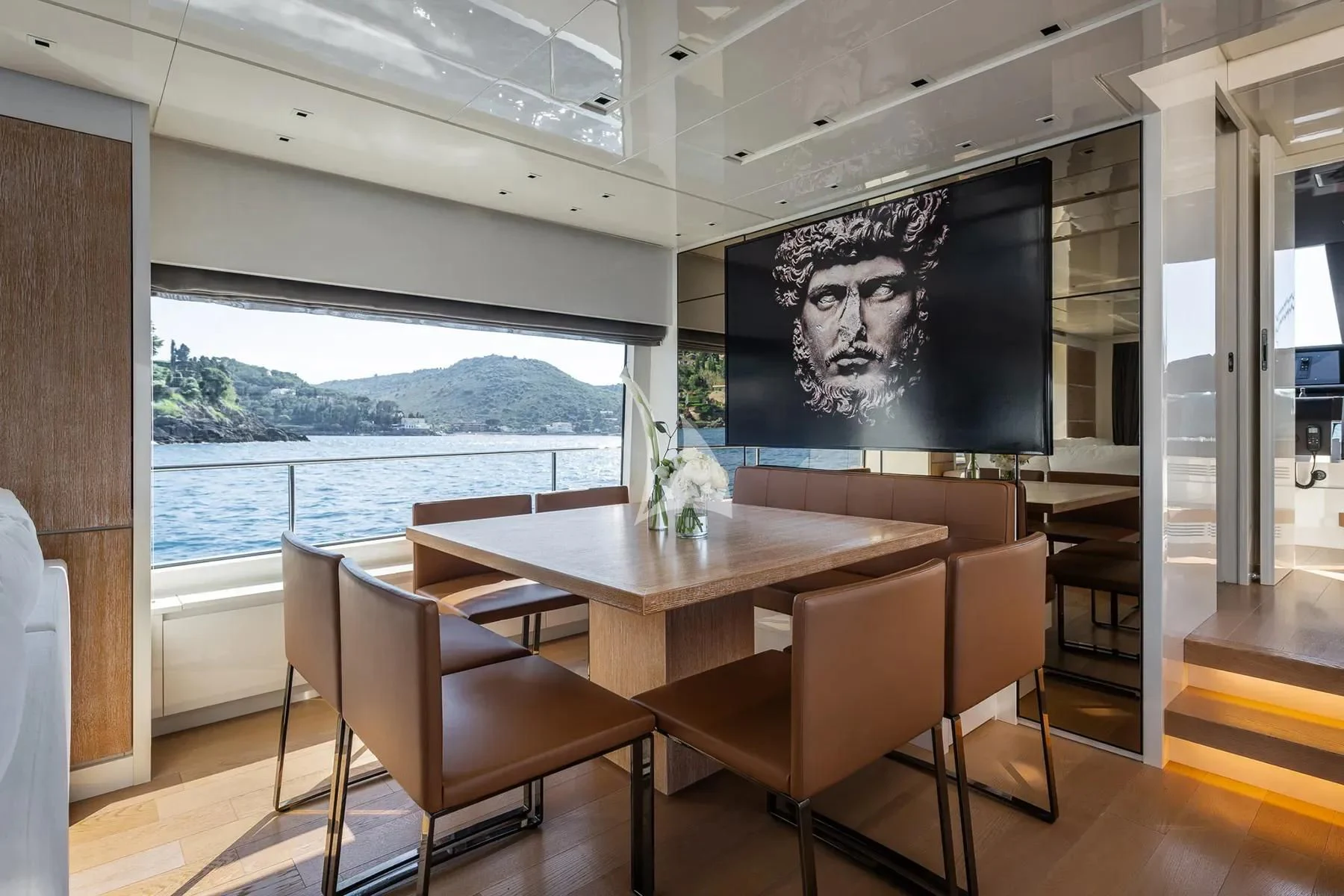 a room with a table and chairs aboard PEMBE Yacht for Charter