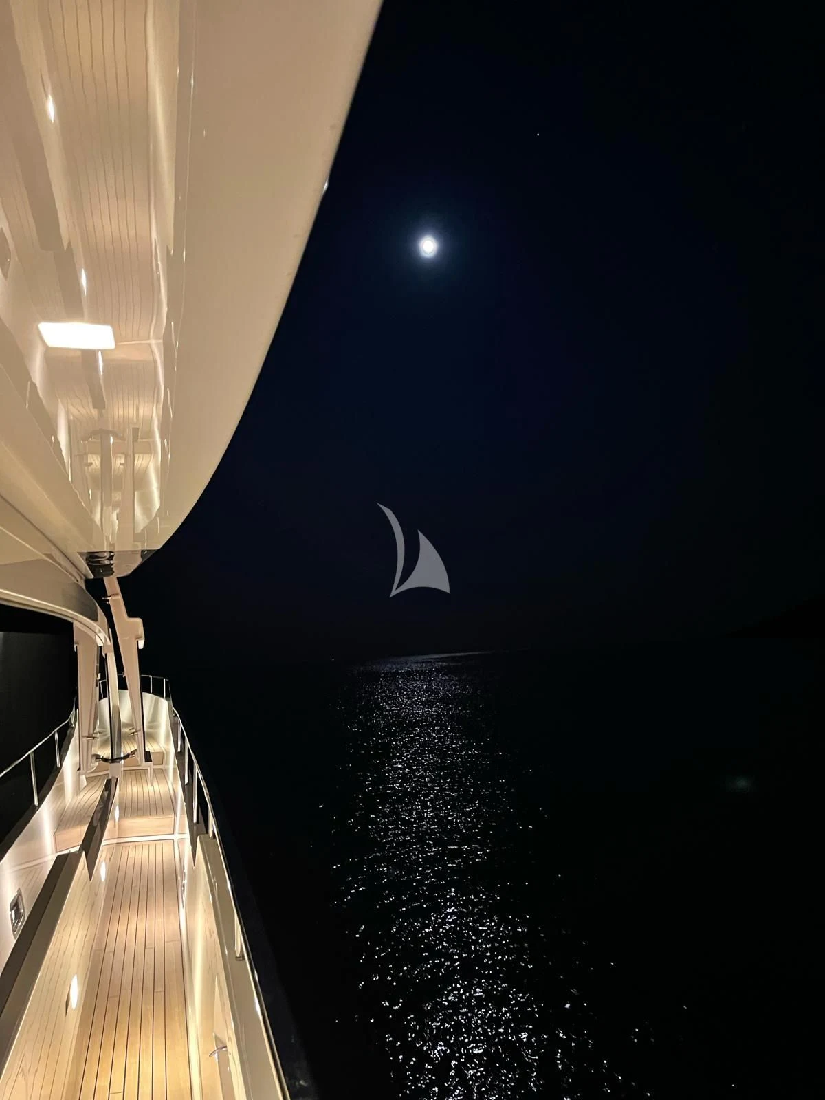 a white crescent moon over a body of water aboard PEMBE Yacht for Charter