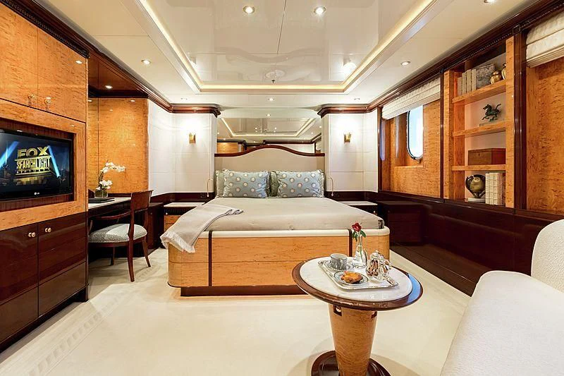 a bedroom with a bed and a tv aboard LUCKY LADY Yacht for Sale