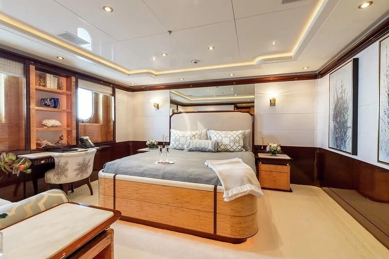 a bedroom with a bed and a desk aboard LUCKY LADY Yacht for Sale