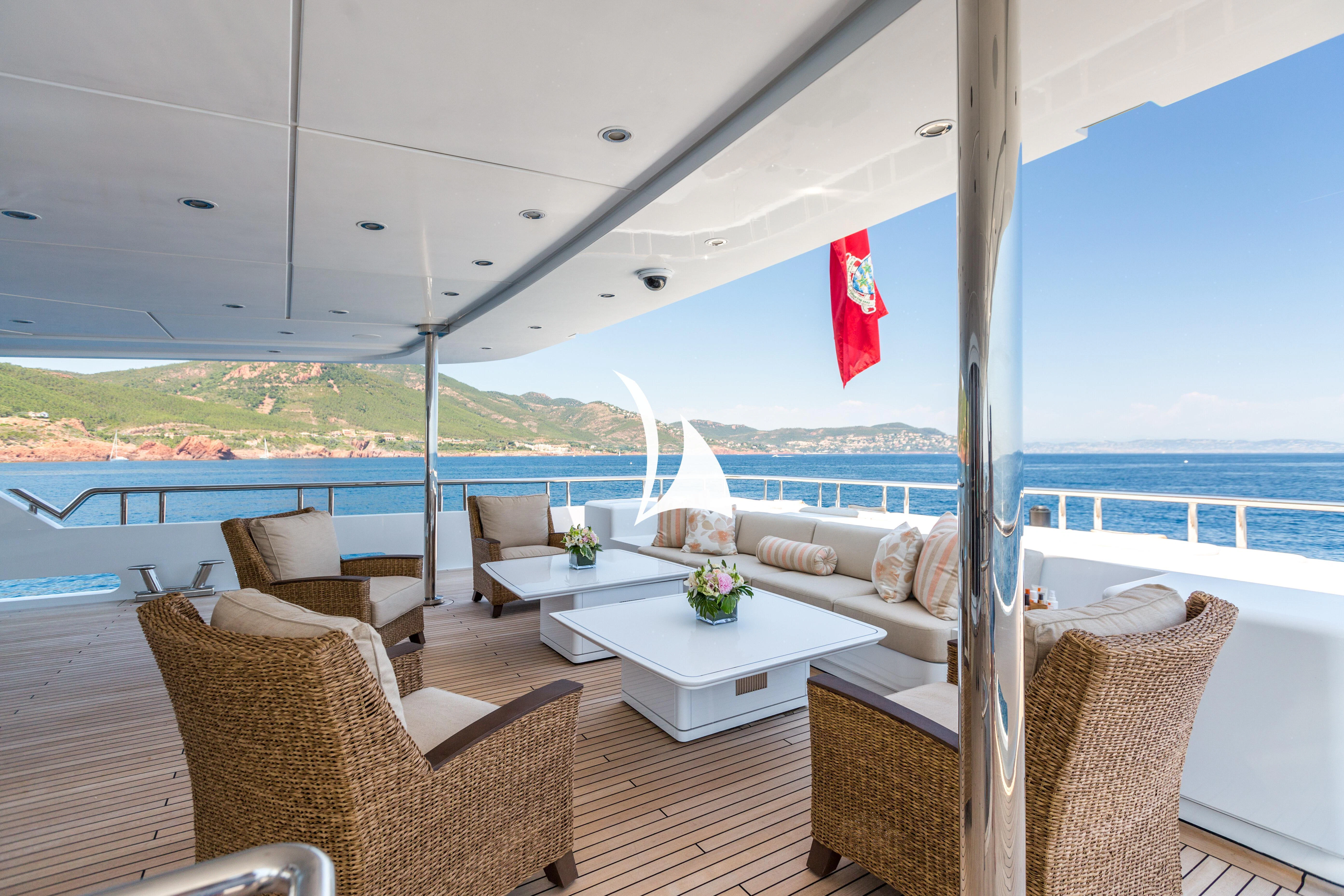 a room with a couch and a table and chairs aboard LUCKY LADY Yacht for Sale