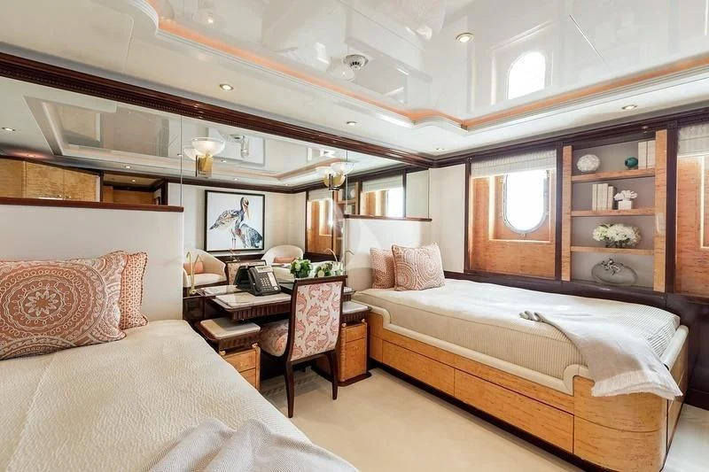 a bedroom with a bed and a desk aboard LUCKY LADY Yacht for Sale