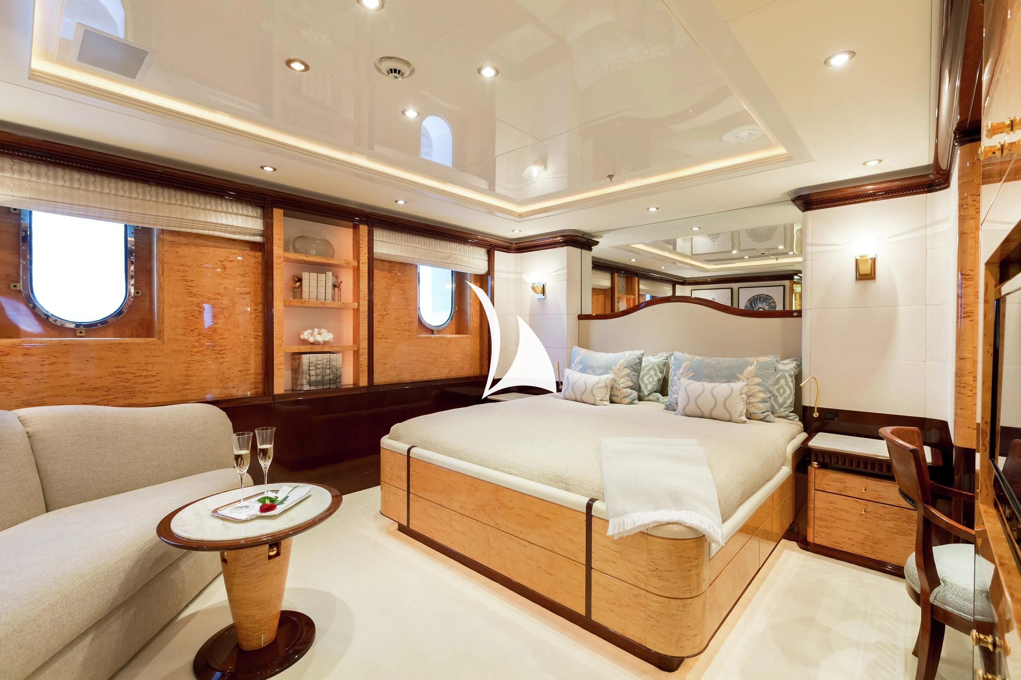 a bedroom with a bed and a table aboard LUCKY LADY Yacht for Sale