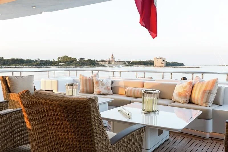 a table with pillows and glasses on it aboard LUCKY LADY Yacht for Sale