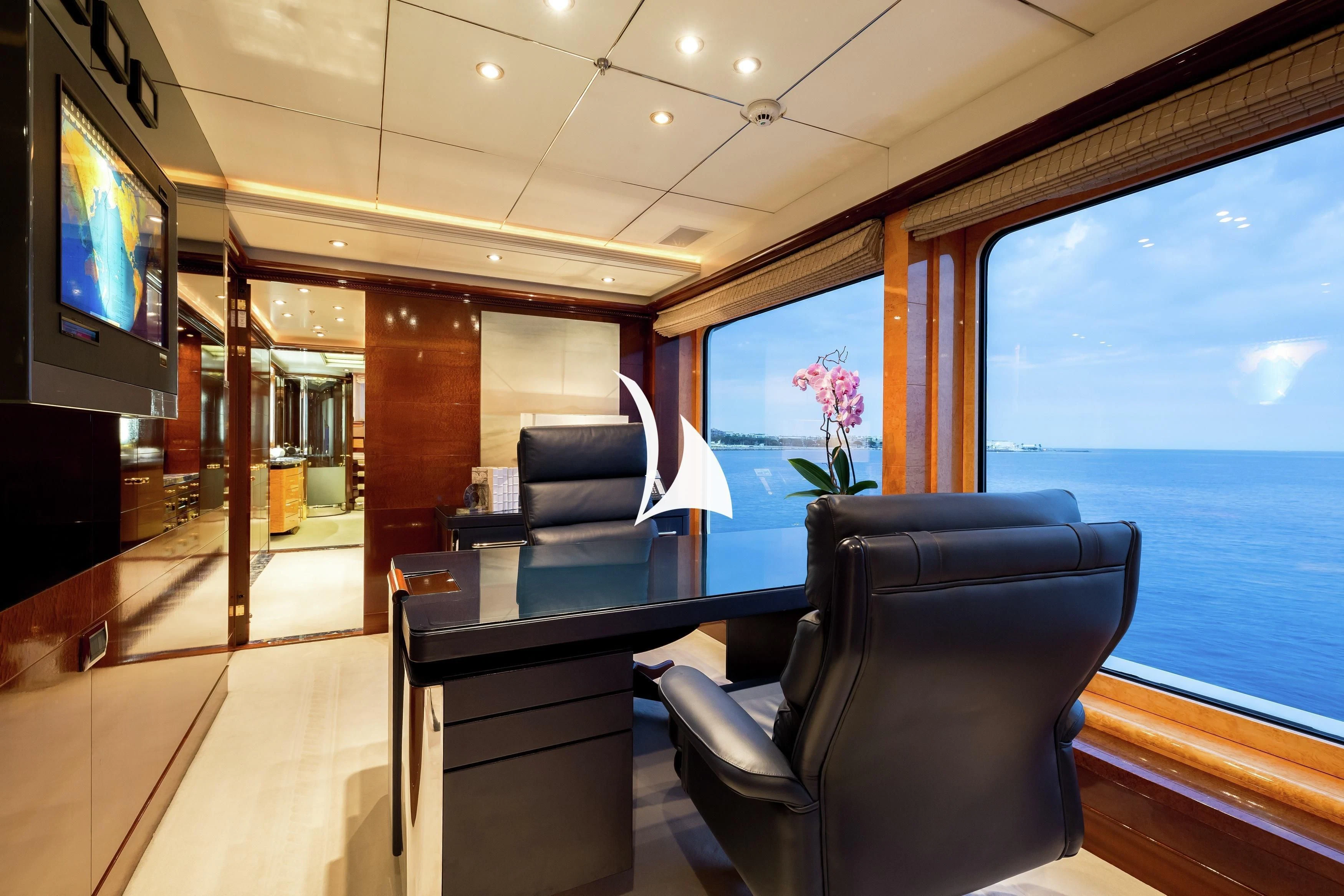 a room with a table and chairs aboard LUCKY LADY Yacht for Sale