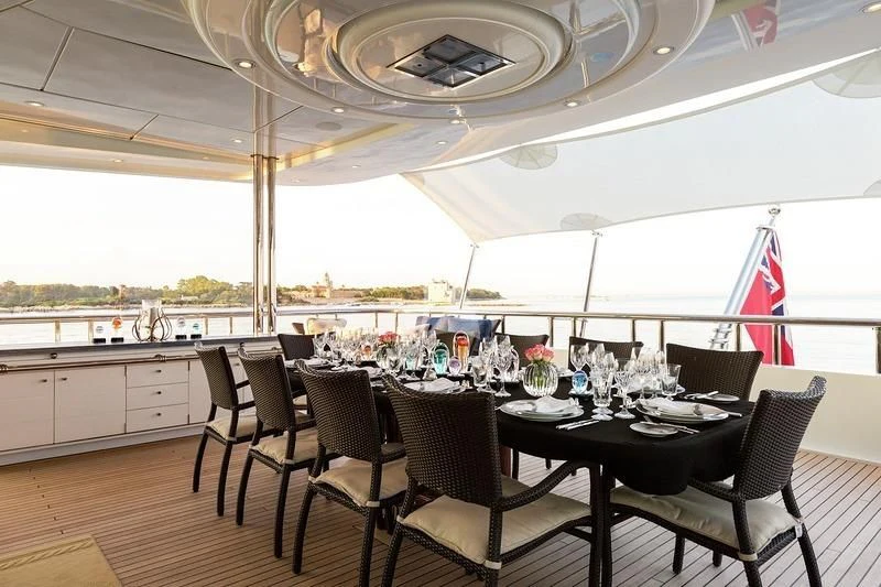 a dining room with a table and chairs aboard LUCKY LADY Yacht for Sale