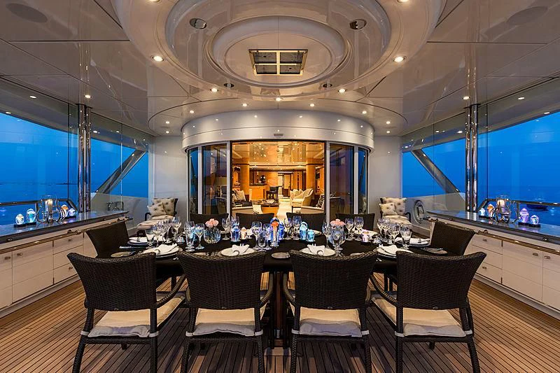 a large kitchen with a large dining table and chairs aboard LUCKY LADY Yacht for Sale