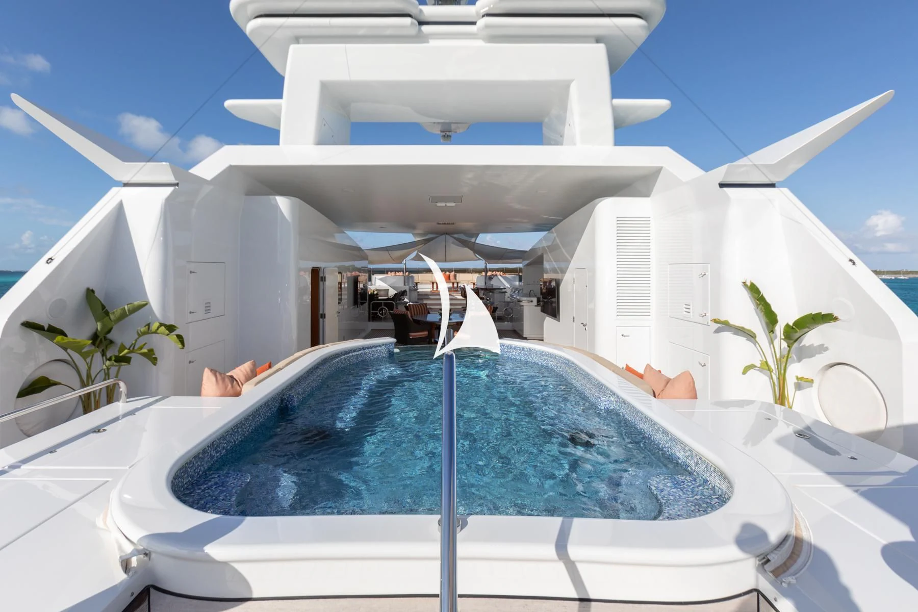 a pool with a large building in the background aboard LUCKY LADY Yacht for Sale