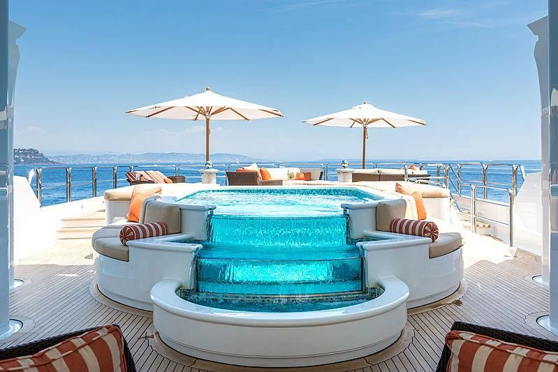 a pool with a large umbrella aboard LUCKY LADY Yacht for Sale