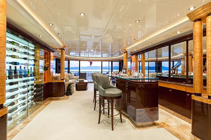 a room with a table and chairs aboard LUCKY LADY Yacht for Sale