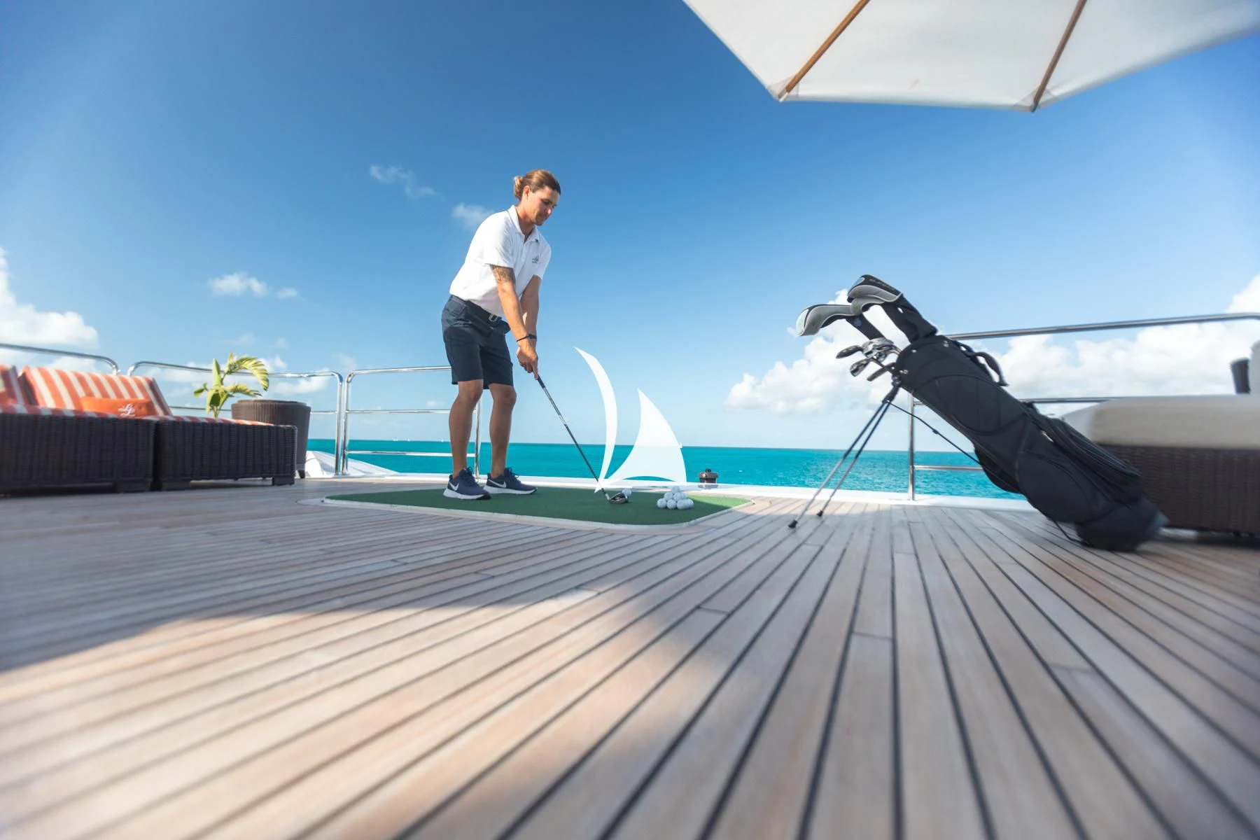 a man playing golf aboard LUCKY LADY Yacht for Sale