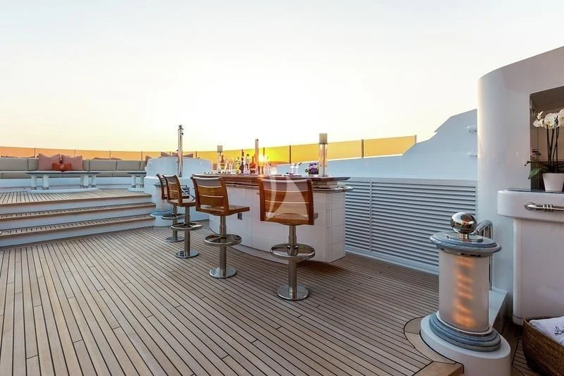 a deck with tables and chairs aboard LUCKY LADY Yacht for Sale