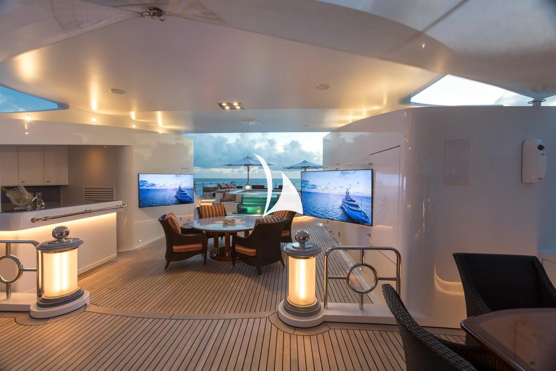 a room with a table chairs and a television aboard LUCKY LADY Yacht for Sale