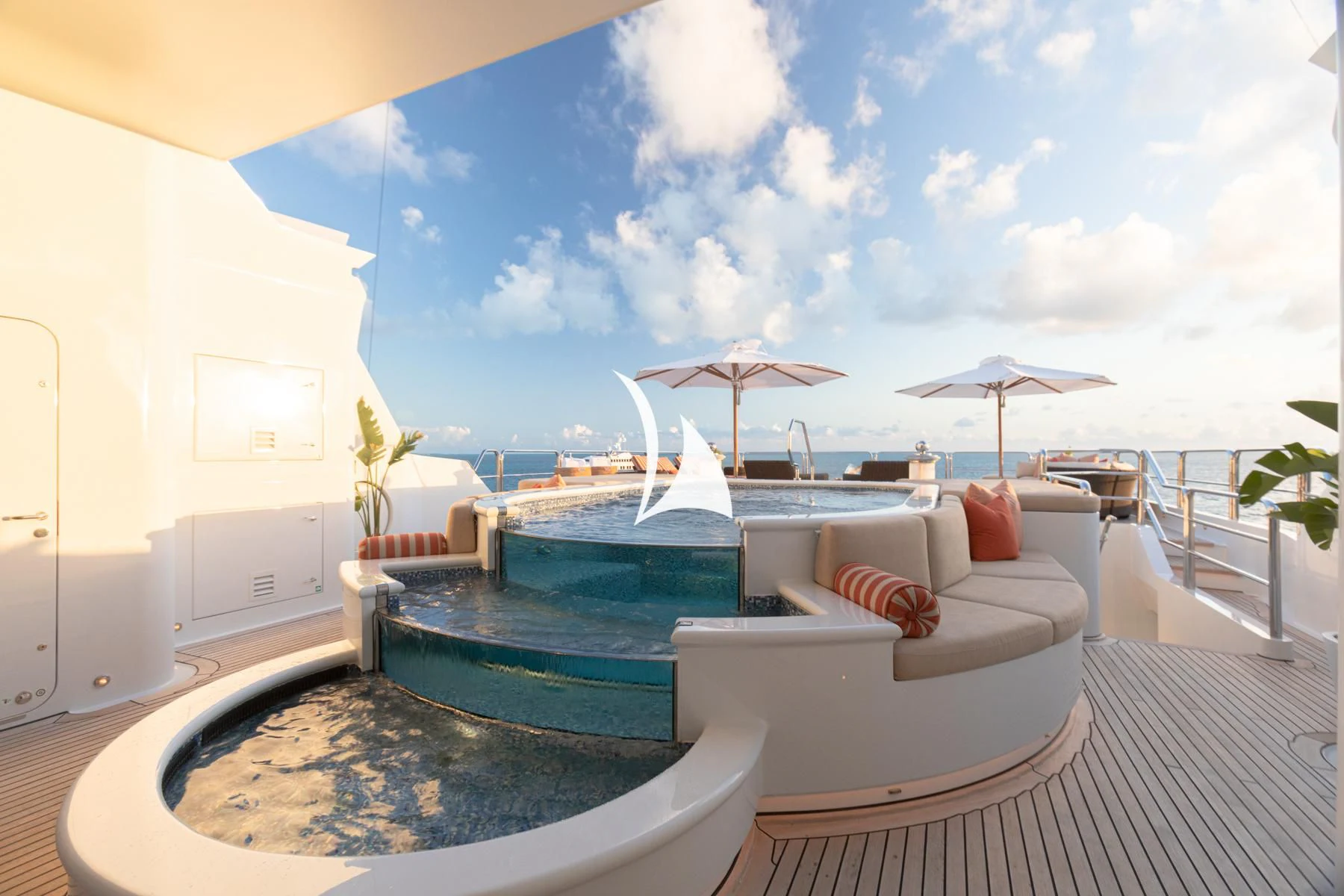a pool with a lounge chair and umbrellas on a deck aboard LUCKY LADY Yacht for Sale